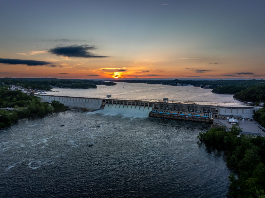 Scenic sunset over Lake of the Ozarks dam and bridge with dramatic sky and waterfront views